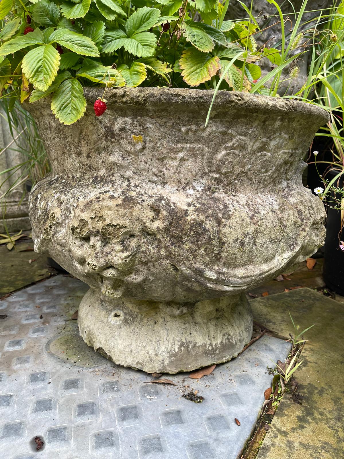 A set of four reconstituted stone circular bulbous garden urns